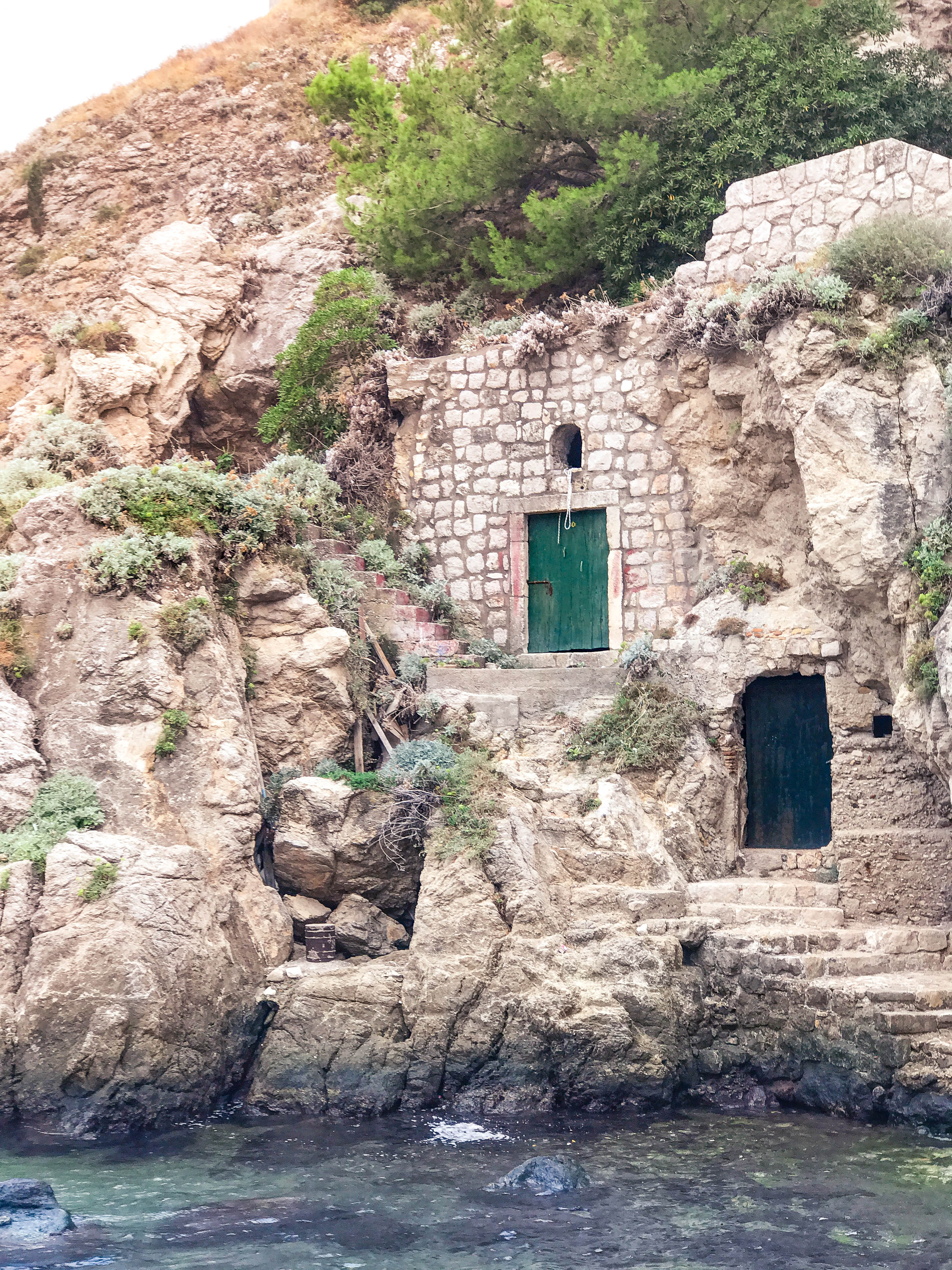 Doors in the cliffside walking up to Fort Lovrijenac (or St. Lawrence Fortress).