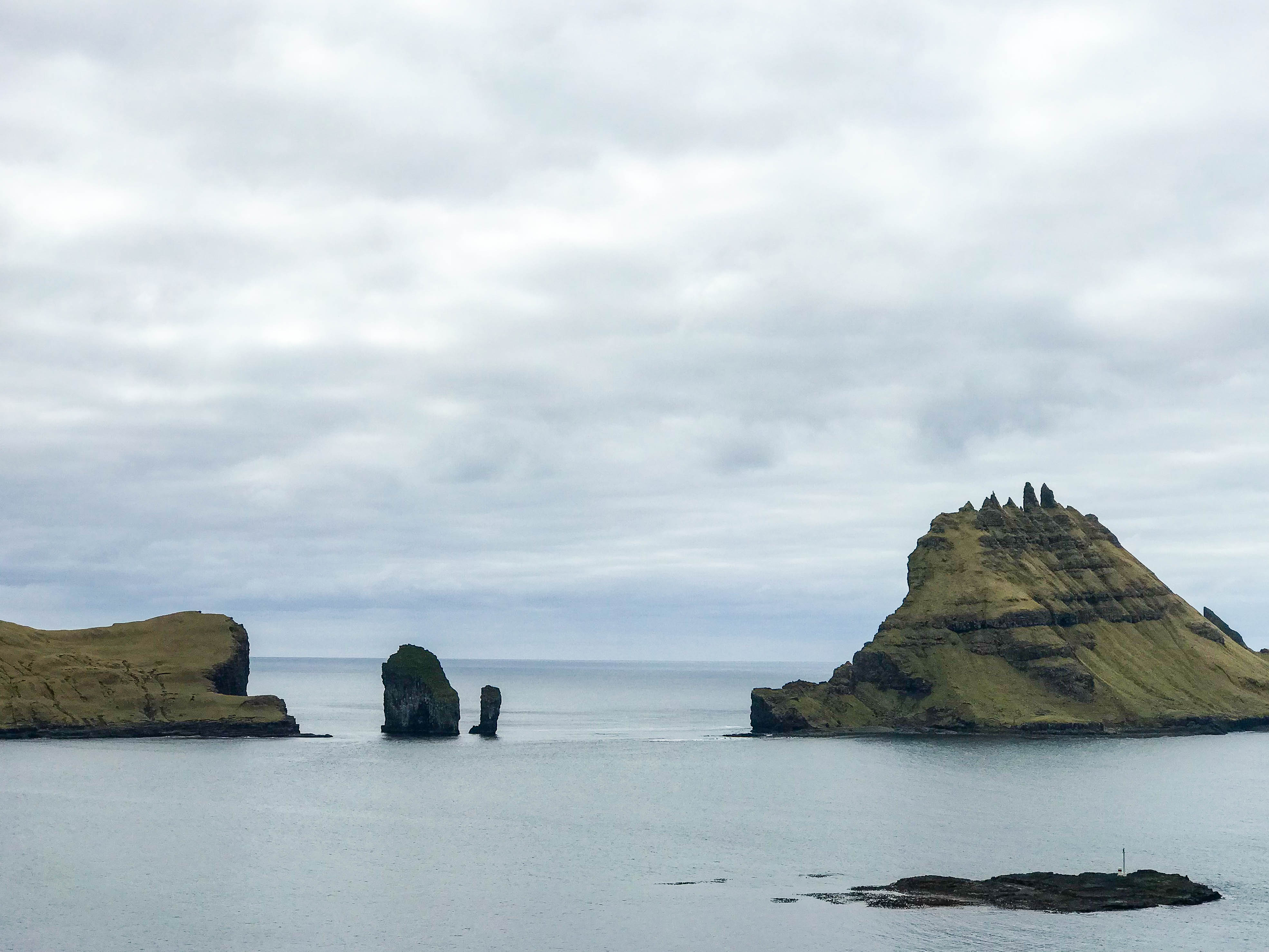 Jagged coastline views on the scenic, coastal drive out to Gásadular | Faroe Islands | CompassAndTwine.com